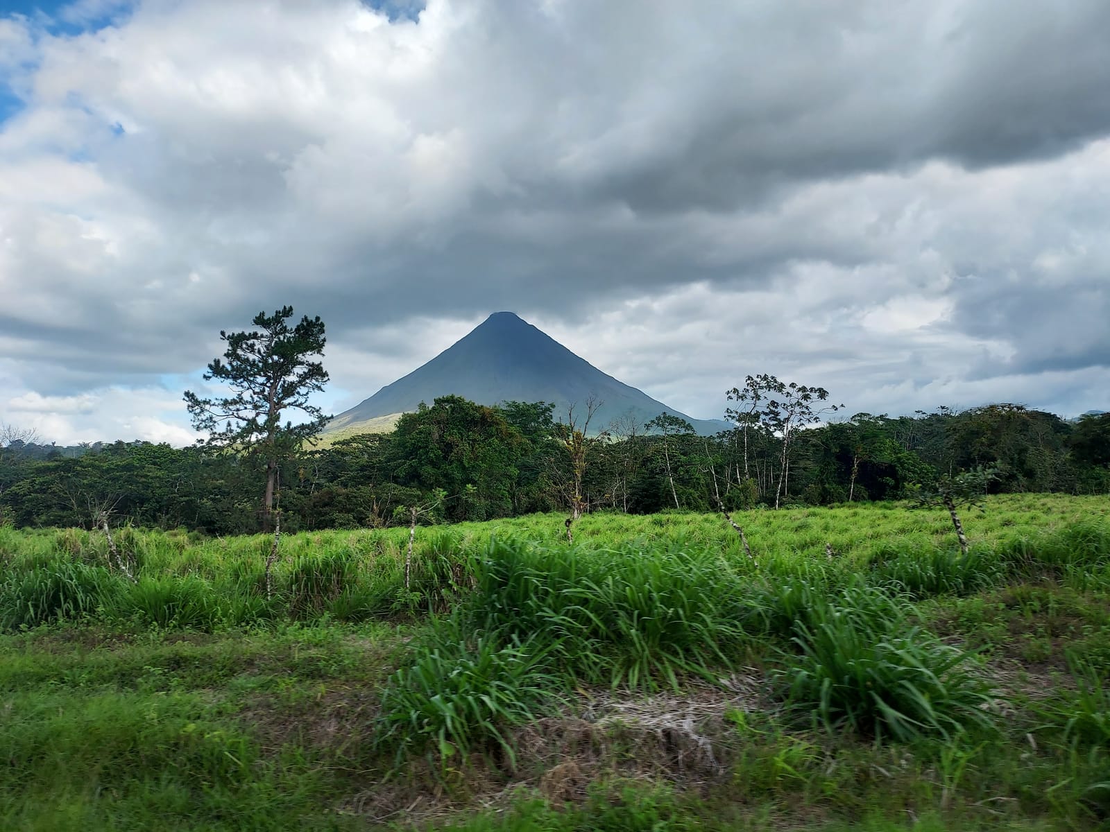 Arenal volcano rising over green countryside